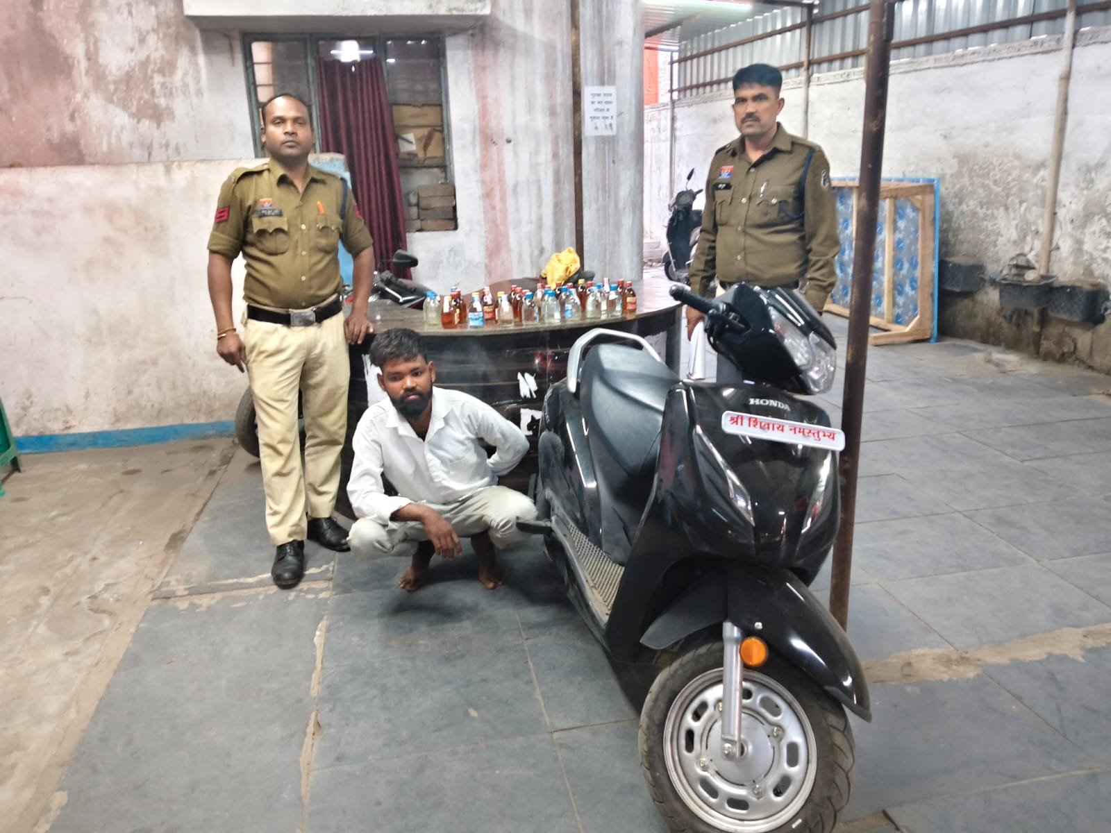 Jute Mill police arrested a youth carrying illegal liquor on a scooter, seized the vehicle along with 32 pounds of country liquor.